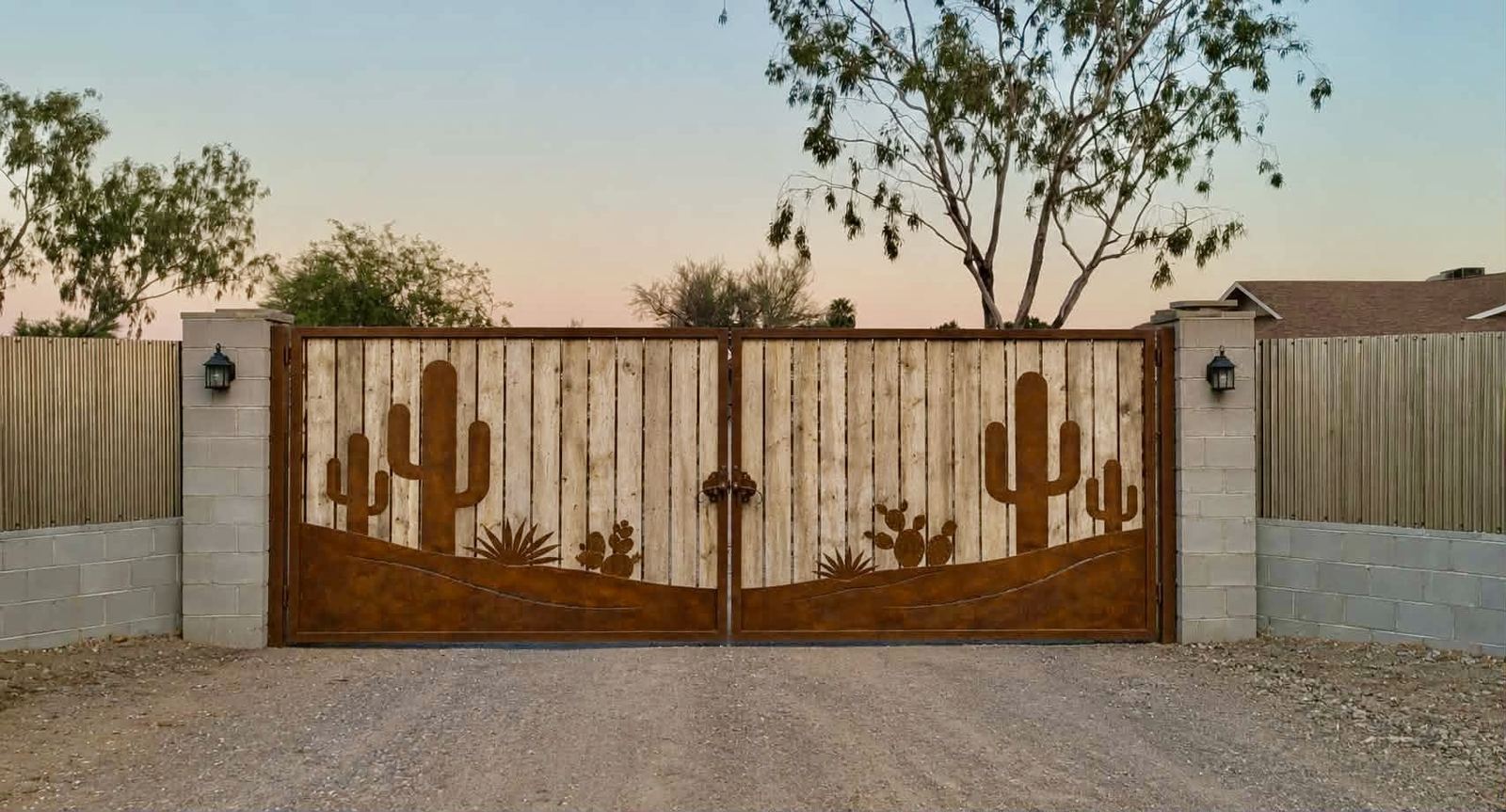 Custom steel driveway gate with saguaro cactus cutouts built by Stein Steel