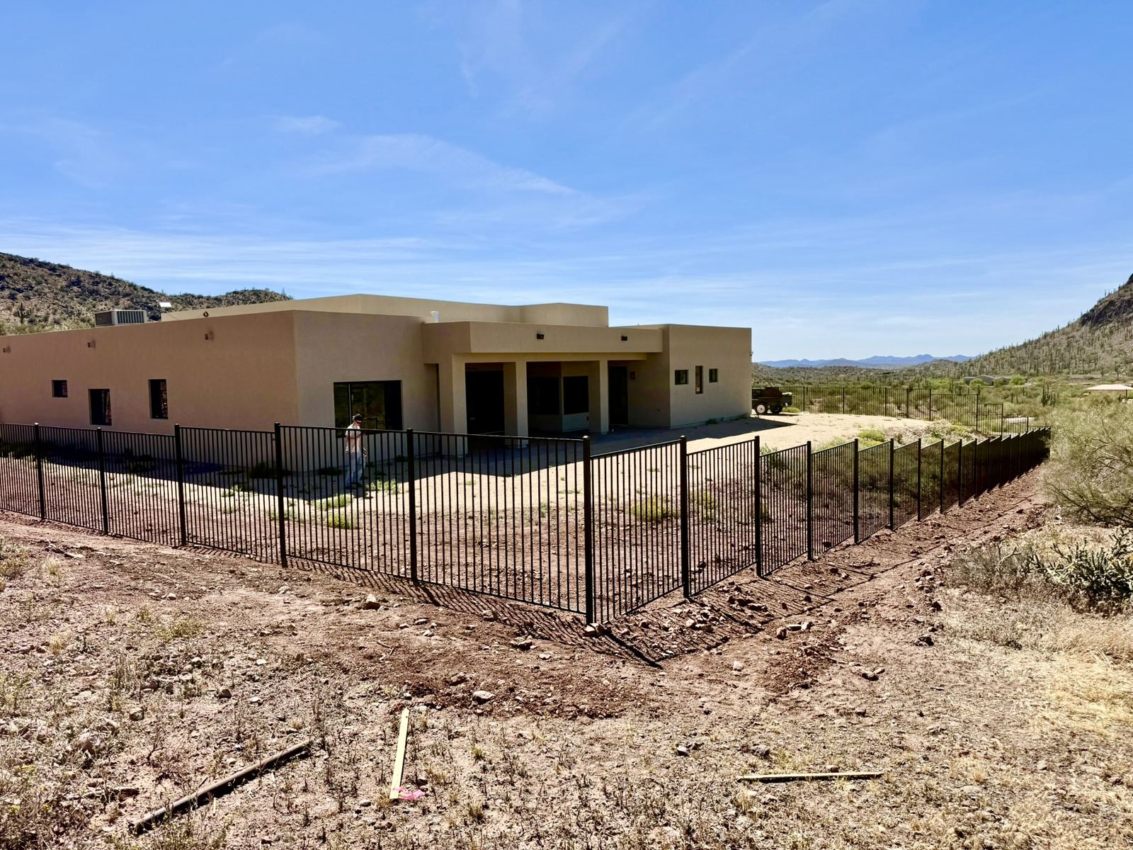Black steel fence around a desert home