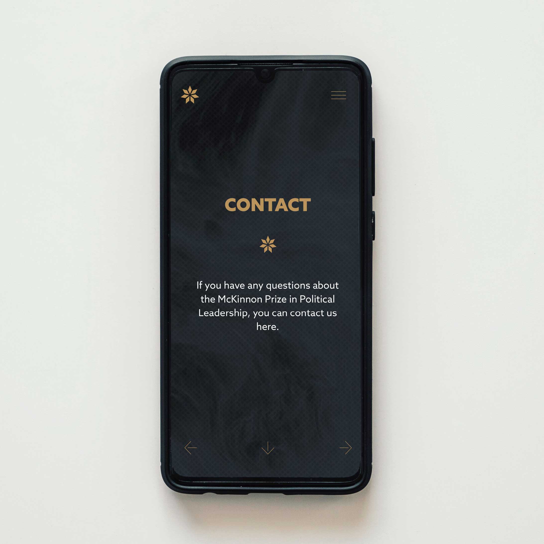 Aerial view of mobile phone with McKinnon Prize contact page showing