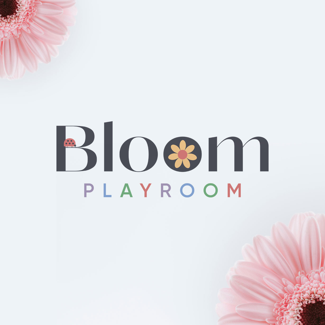 Bloom Playroom logo that is black with colourful lettering and graphics of a flower and a ladybird. In the top left and bottom right corner is a pink flower.