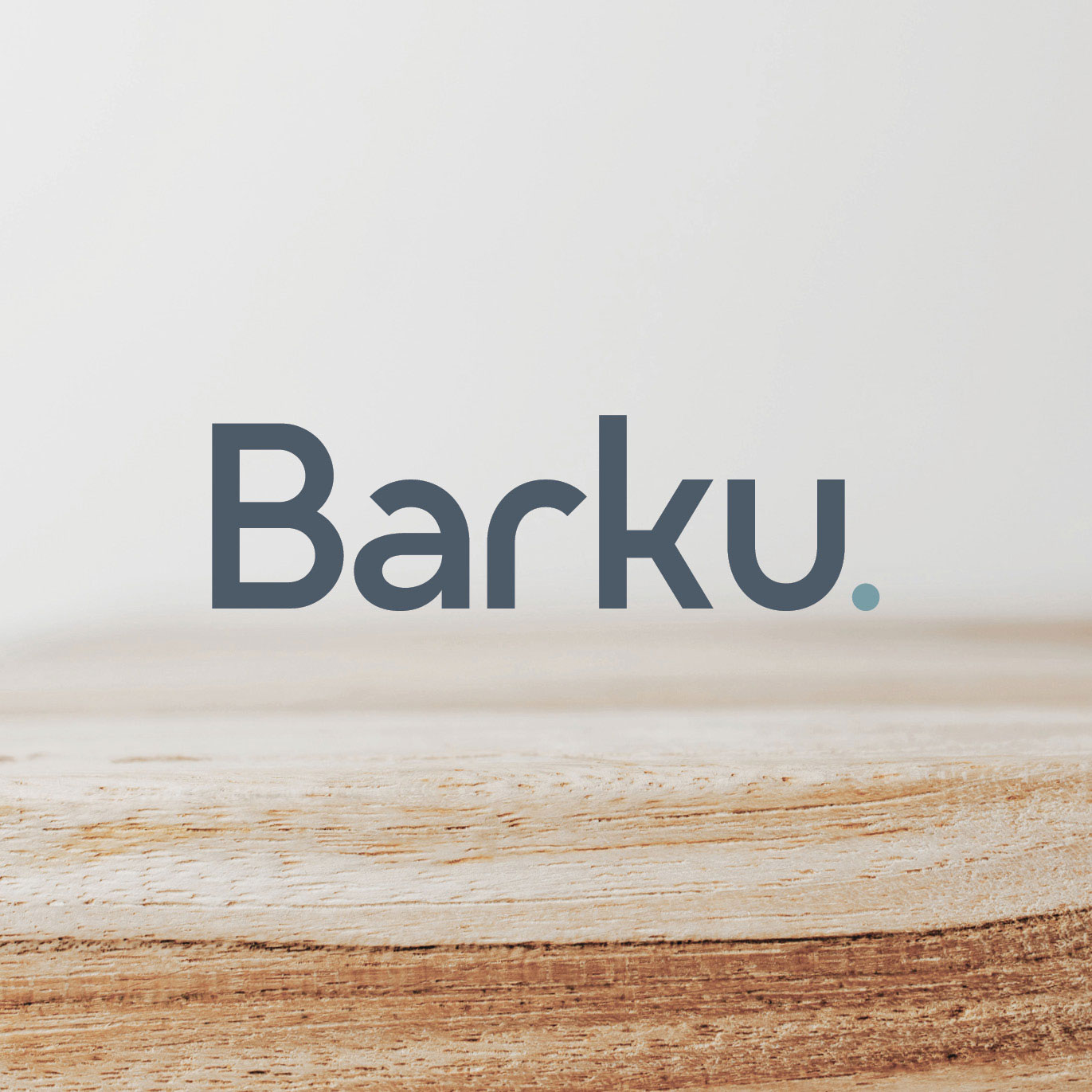 Barku tile - a logo sits in the centre over a close-up image of a light coloured piece of timber.