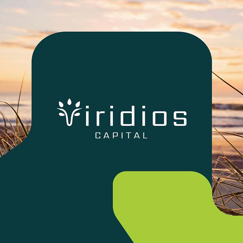 Viridios Capital logo in centre. Background has image of the beach at sunrise, and the foreground has two brand shapes in green and dark green.