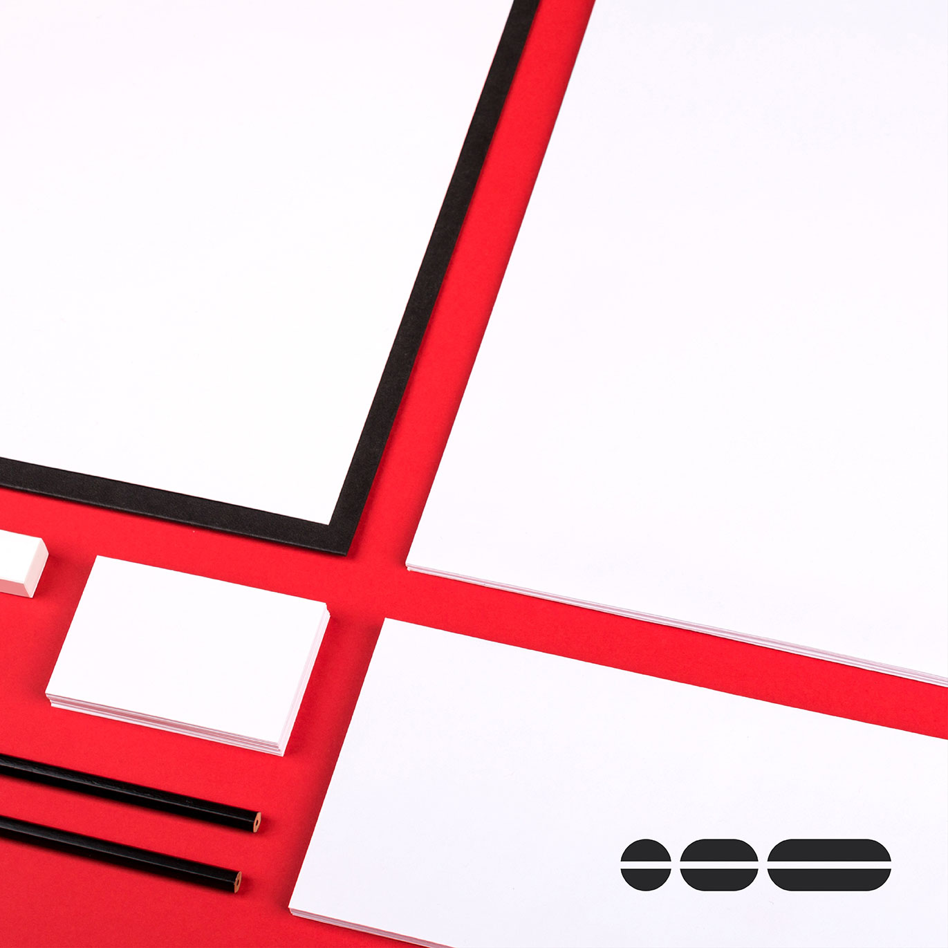 Angled aerial view of blank paper and stationery, ready for new branding to be applied. This represents brand guidelines.