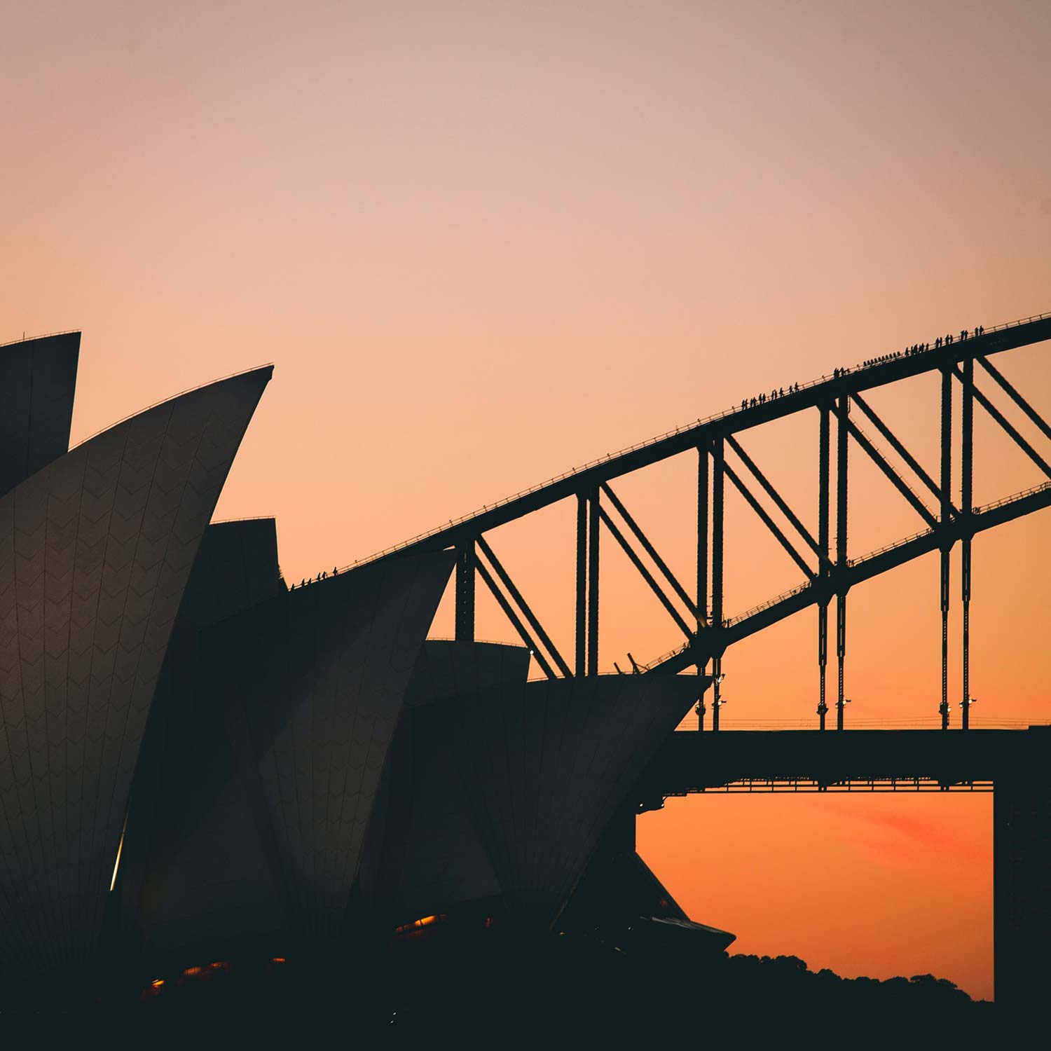 Sunset view of Sydney's Opera House and the south edge of the Sydney Harbour Bridge
