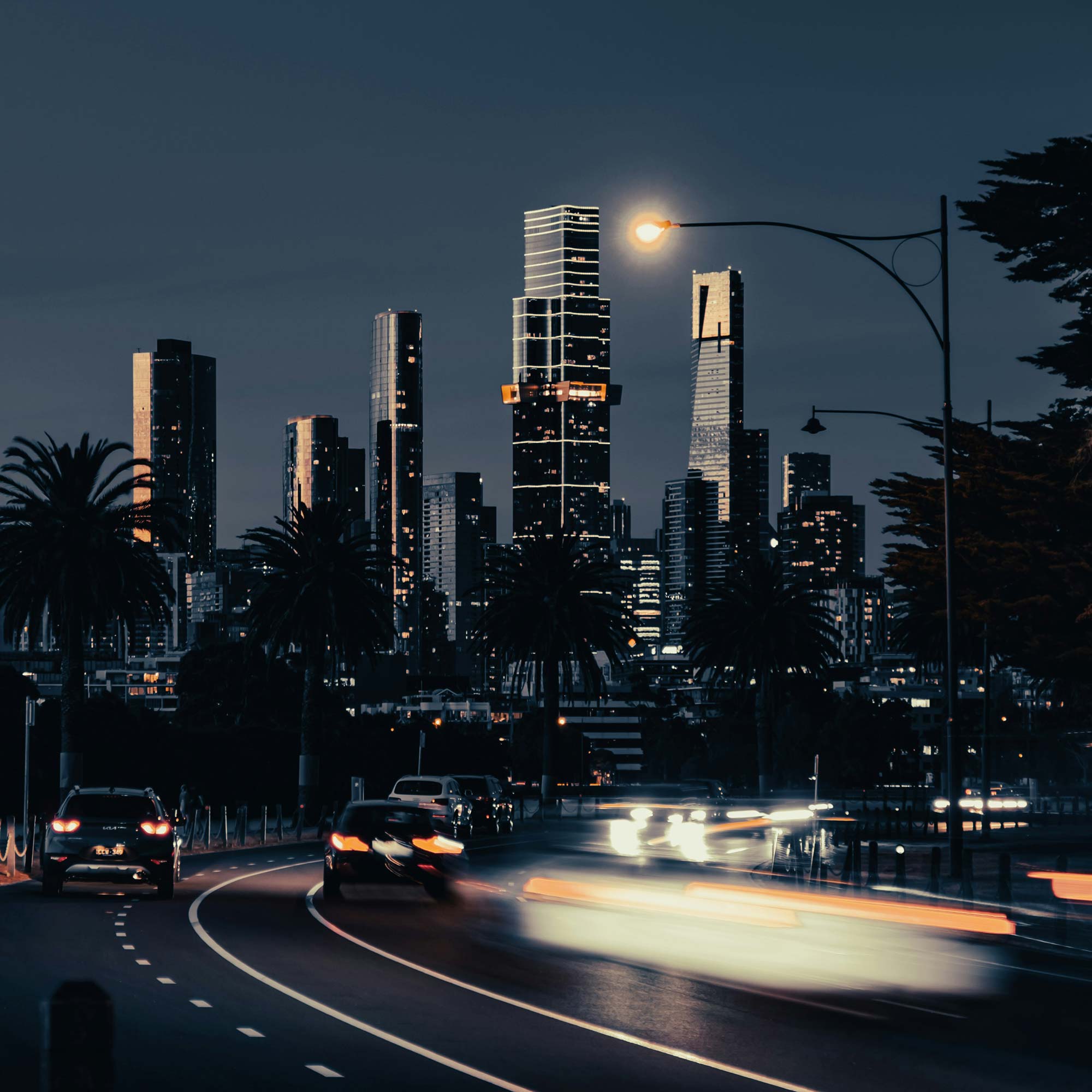 Melbourne CBD at at night with cars heading to the city.