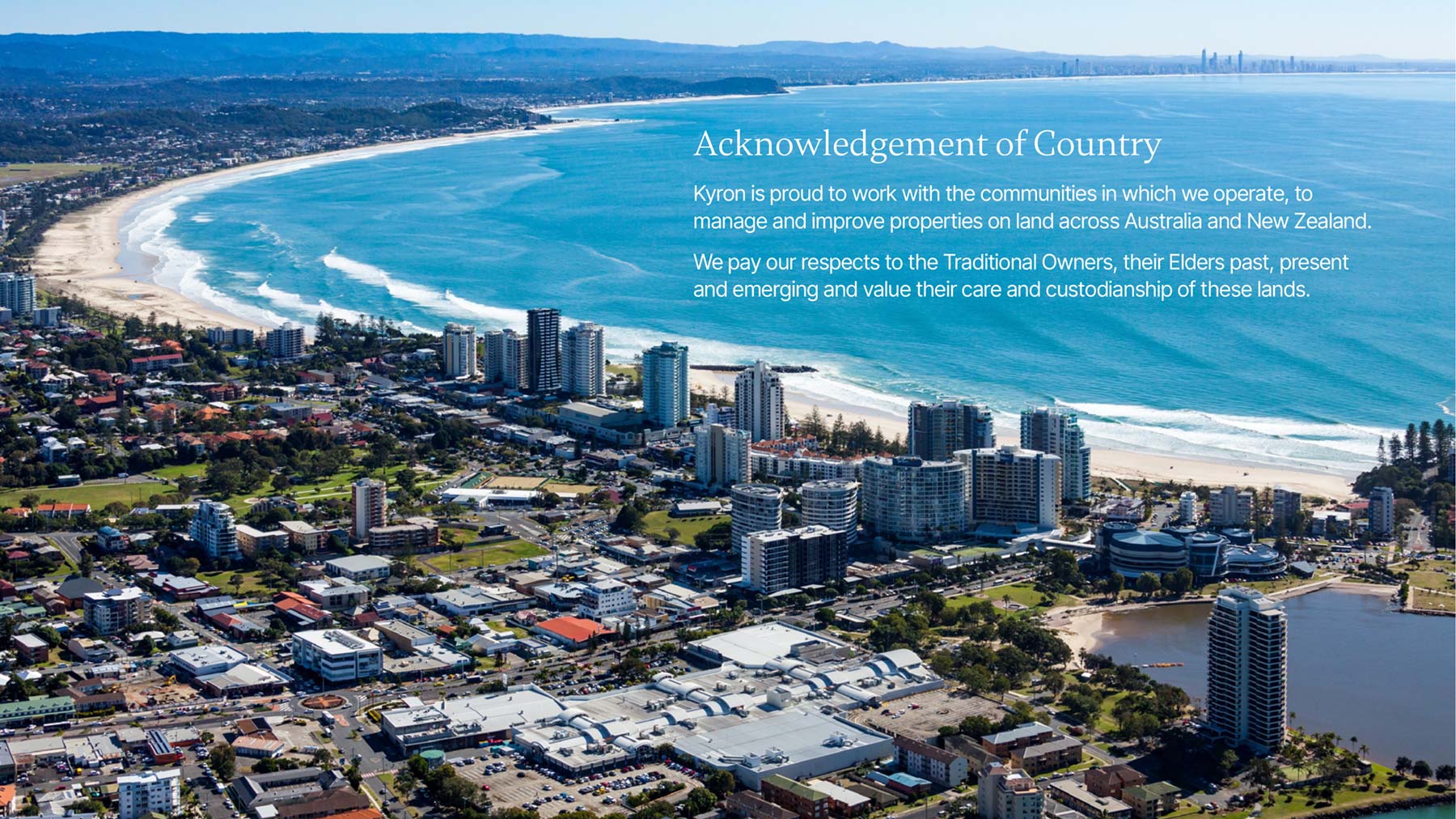 Kyron widescreen PowerPoint template acknowledgement page with image of the beach, and high rises with text over the top
