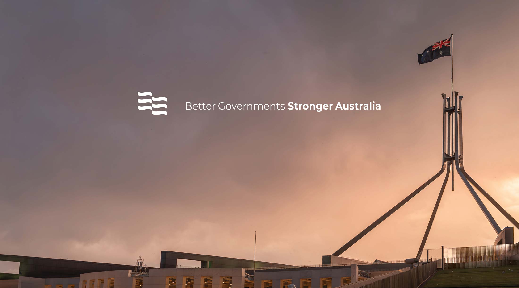 McKinnon boardroom wall art with sunset photo of Parliament House in Canberra with the tagline and icon over the top of the image