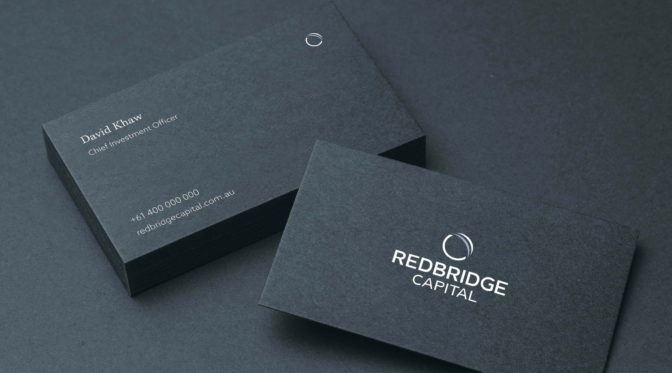 Redbridge Capital business cards on navy stock