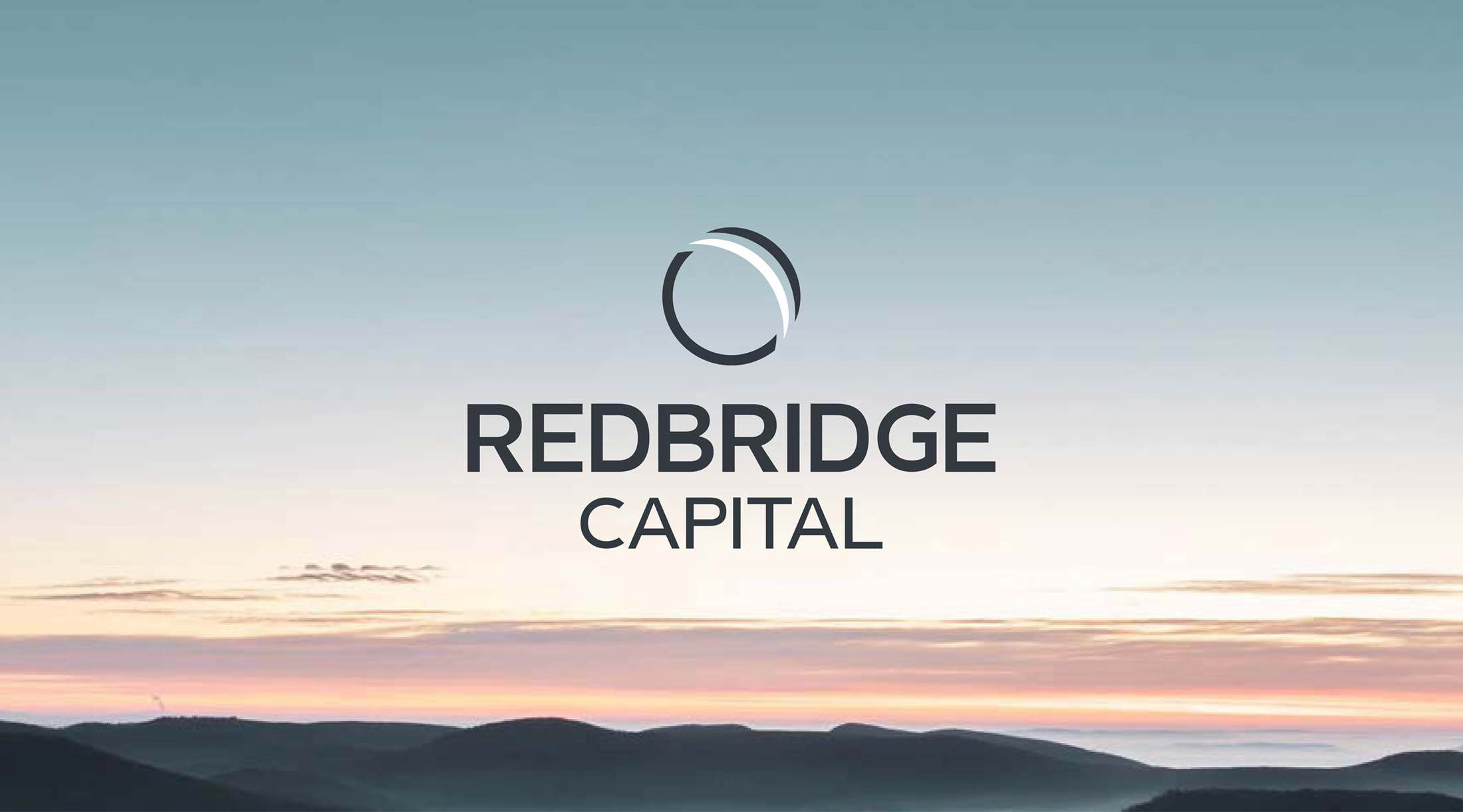 Redbridge Capital logo on sunset image background