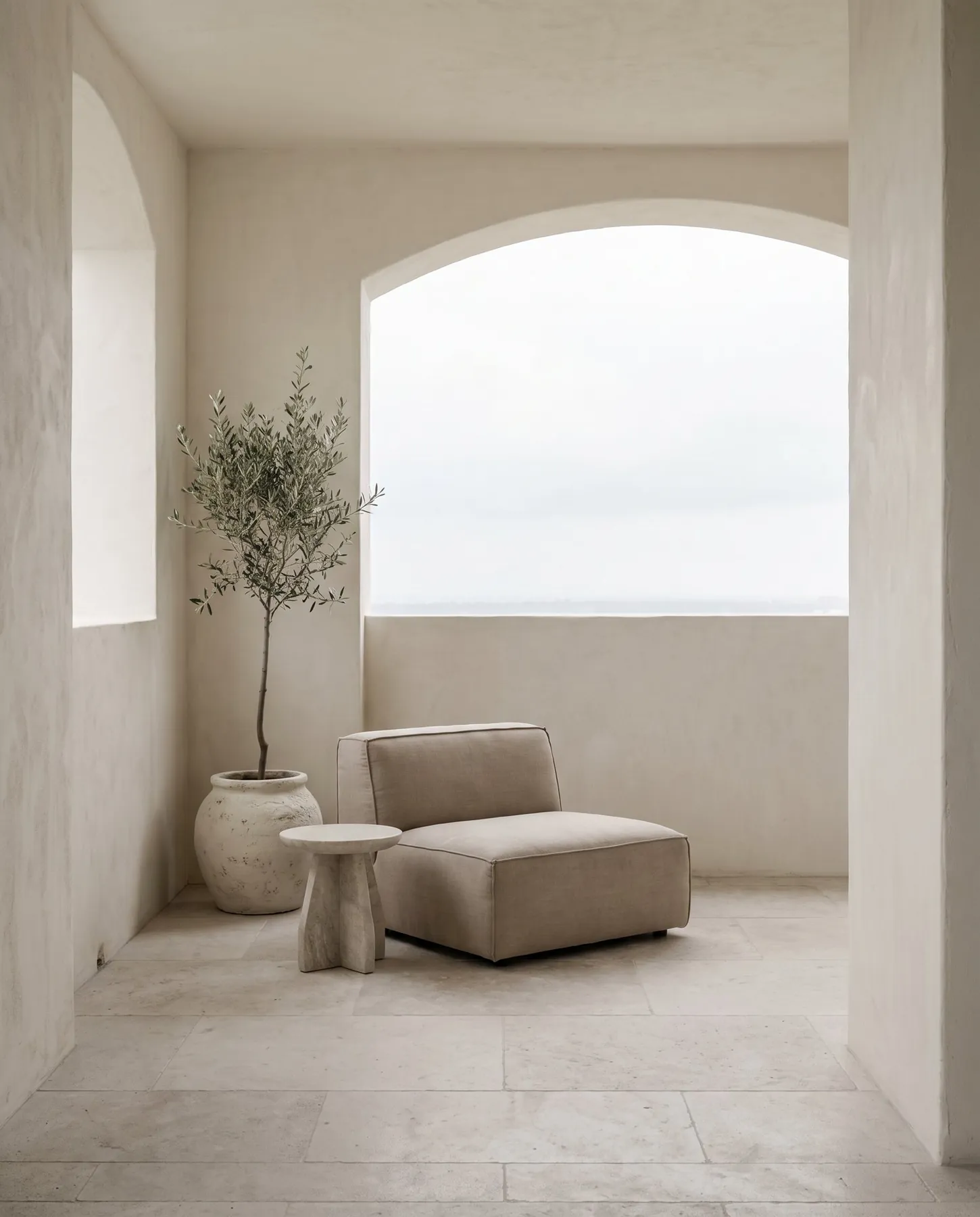 Model residence loggia at Grove House with an olive tree and lounge chair