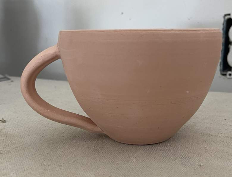 An unglazed clay cup study in progress.