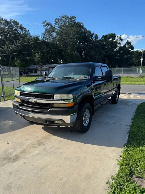 Green Chevy Silverado 2500HD freshly detailed in a driveway