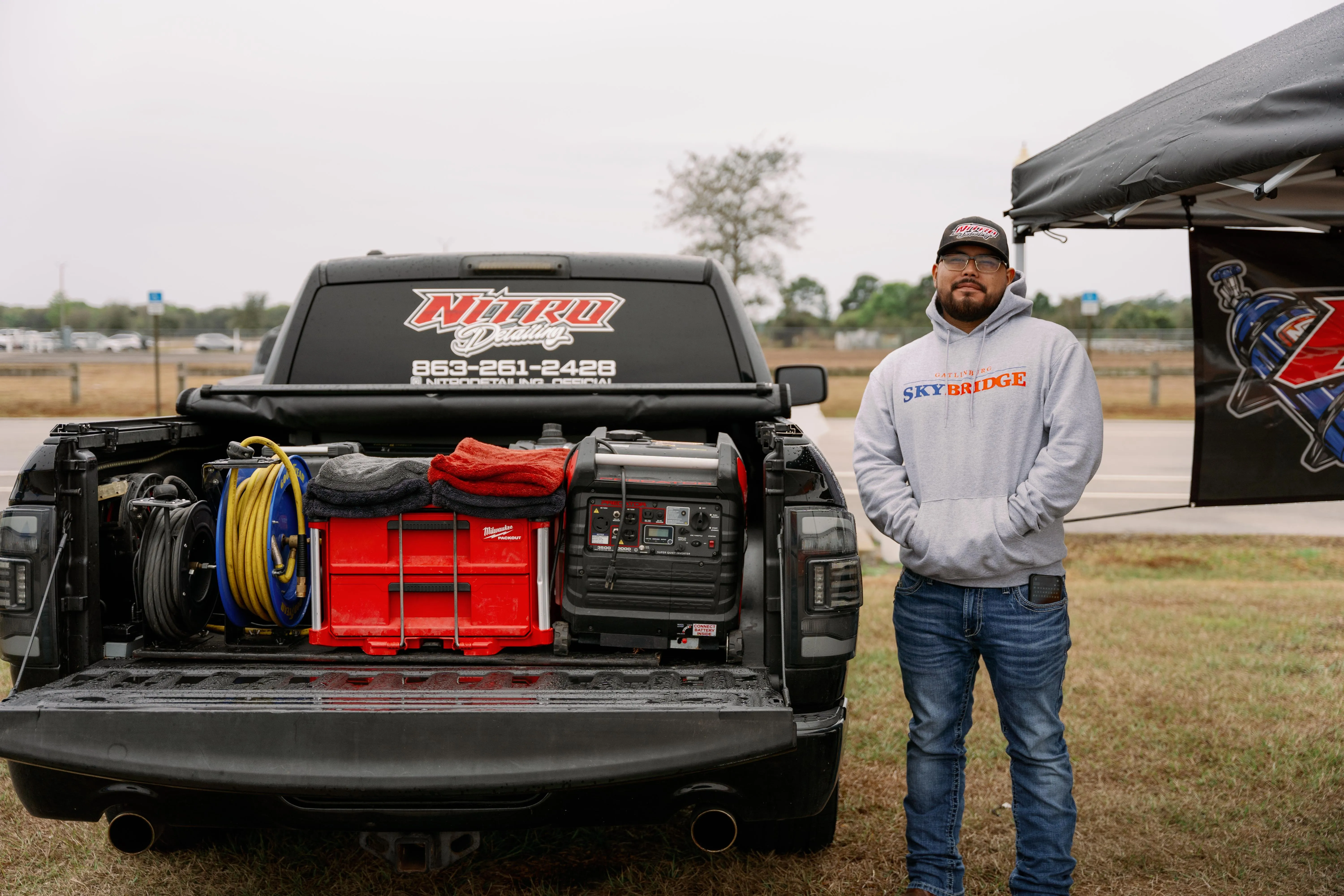 Imri Morales, owner of Nitro Detailing, beside his mobile detailing truck and equipment in Okeechobee
