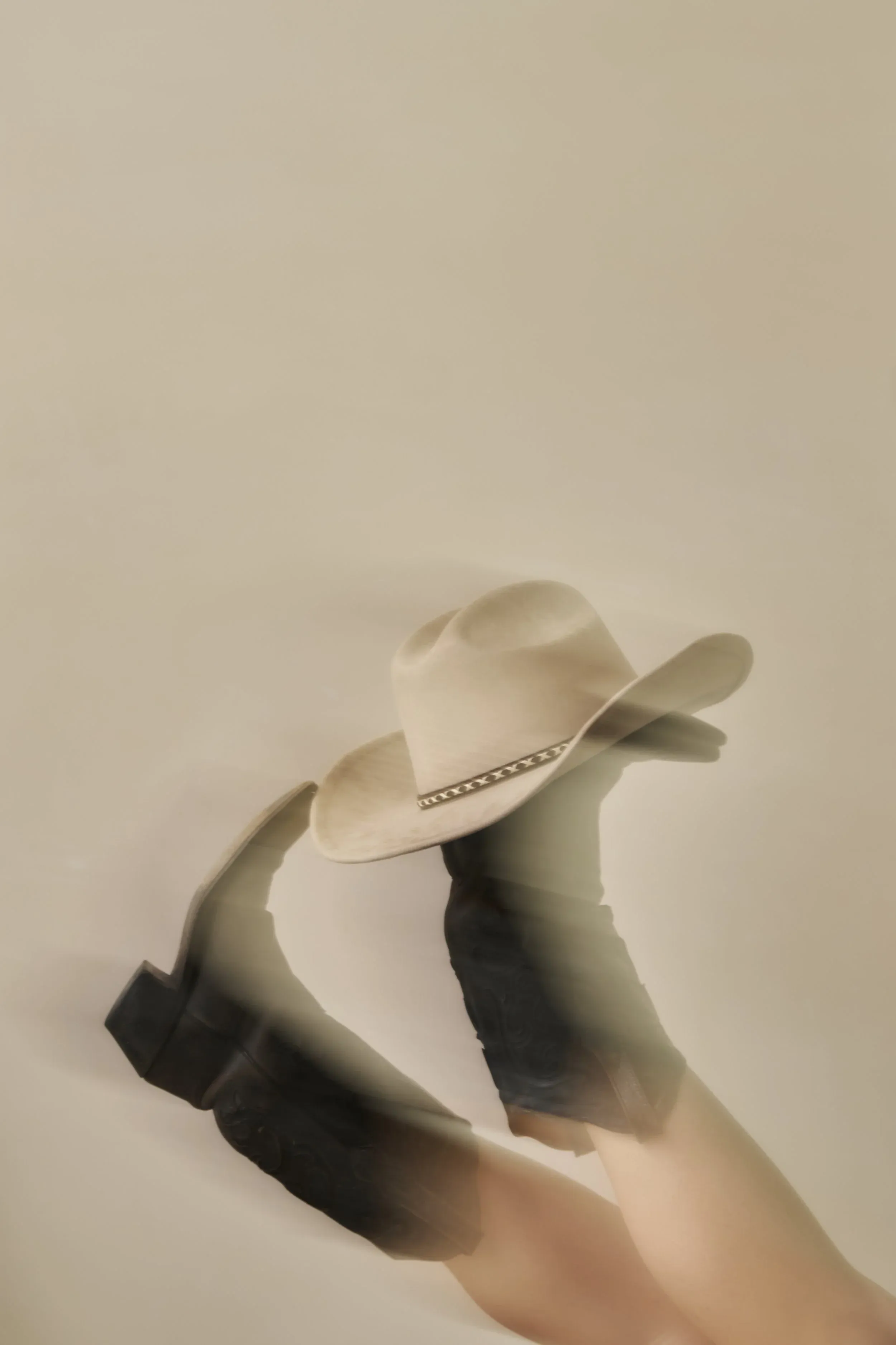 Boots and a hat in an editorial still life