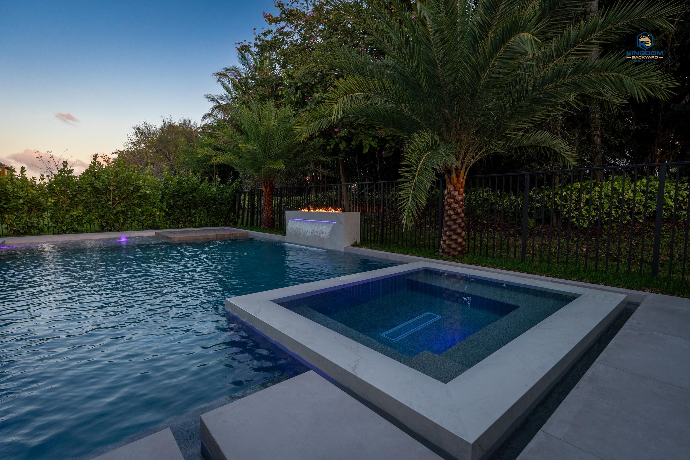 Finished Kingdom Backyard pool and raised spa in Boca Raton at dusk