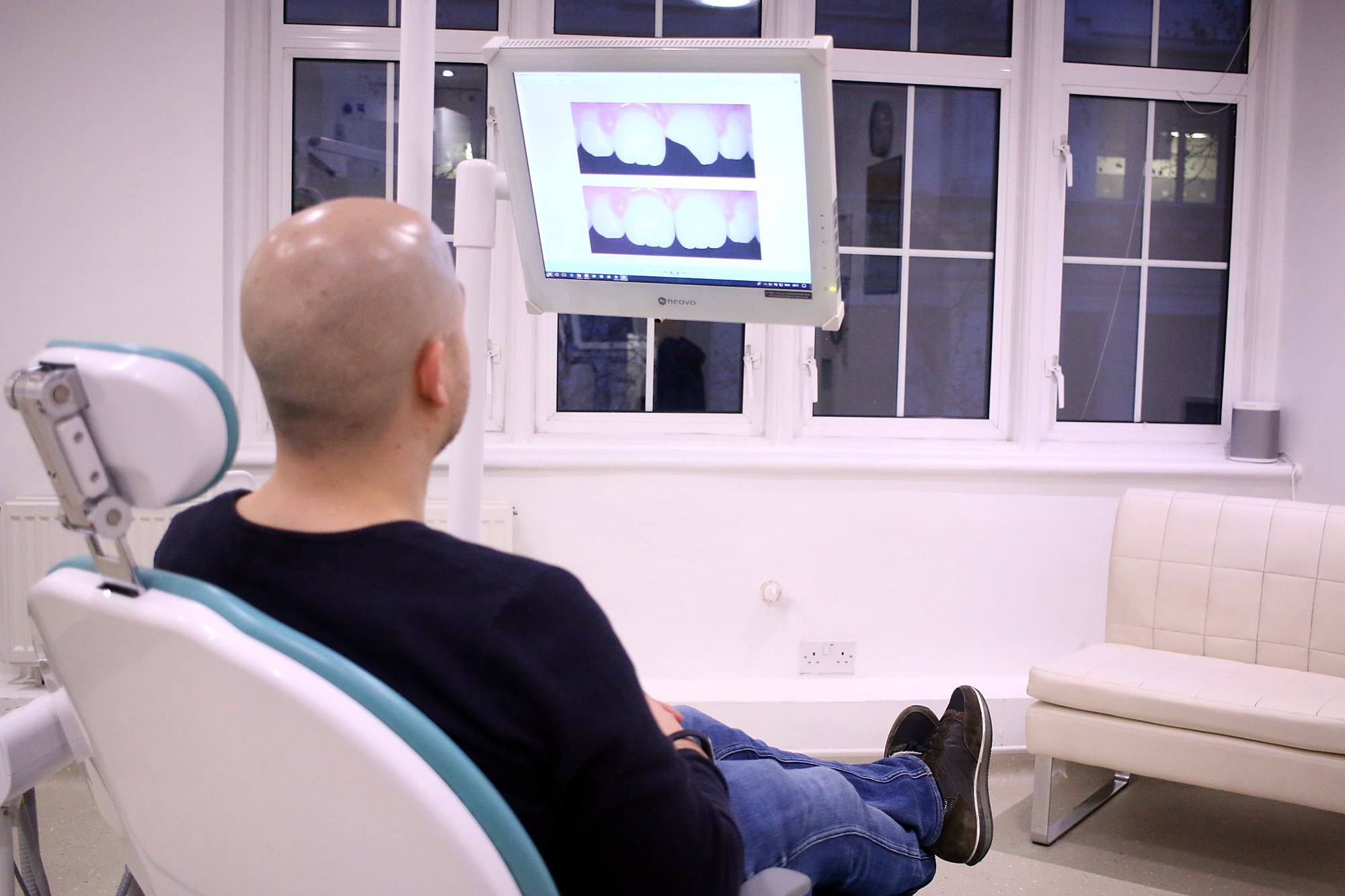 A patient reviewing their scan on screen