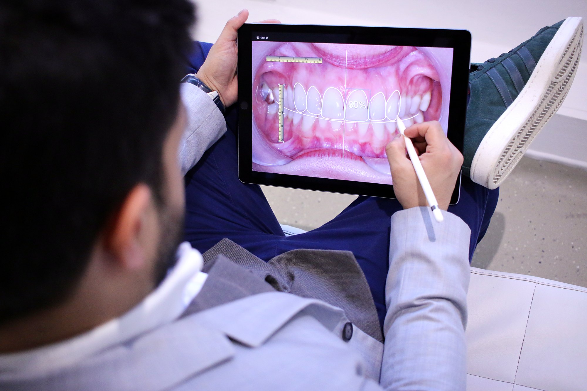 Photographs of teeth reviewed on a tablet