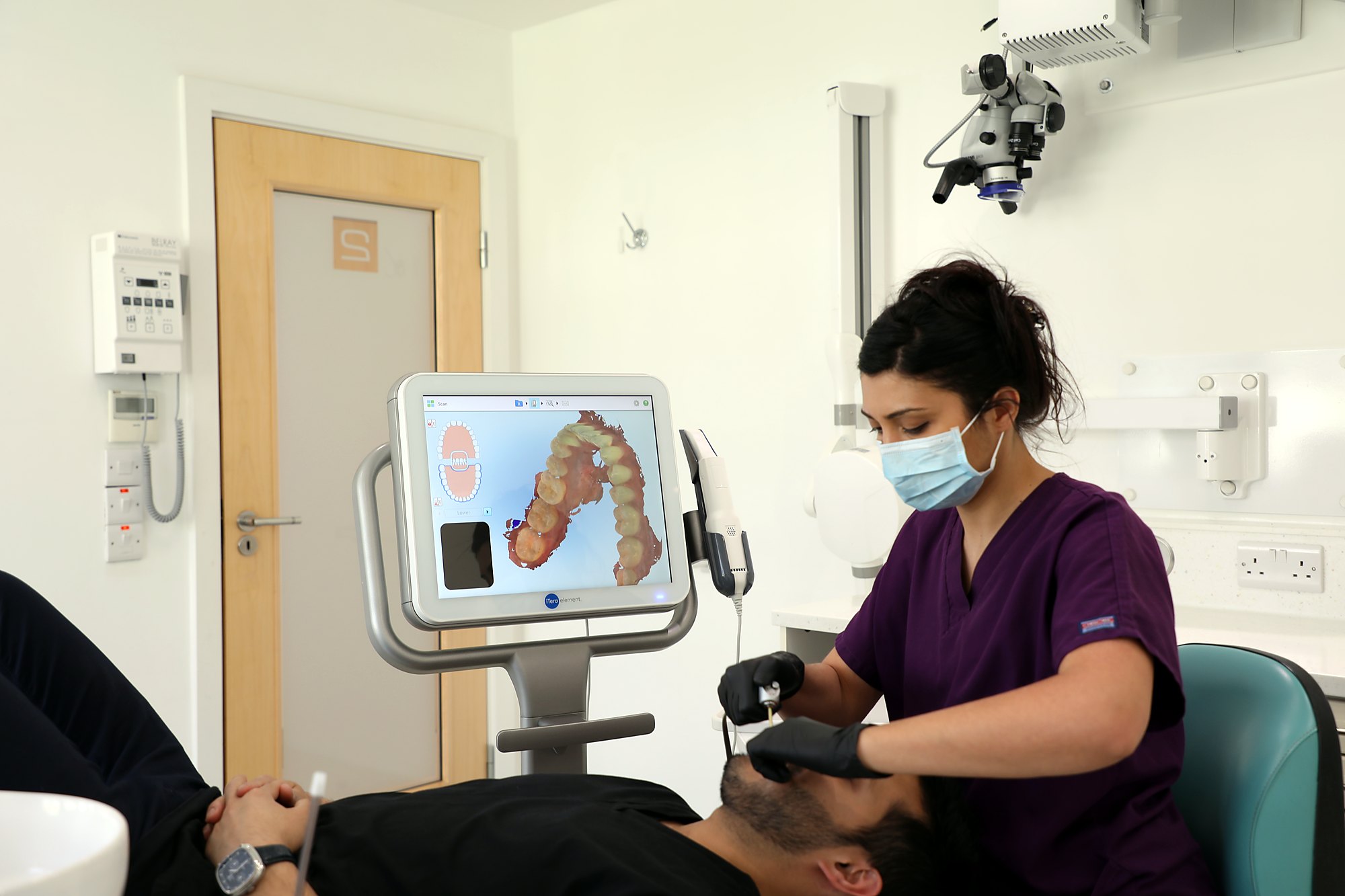 A clinician scanning a patient with the iTero scanner
