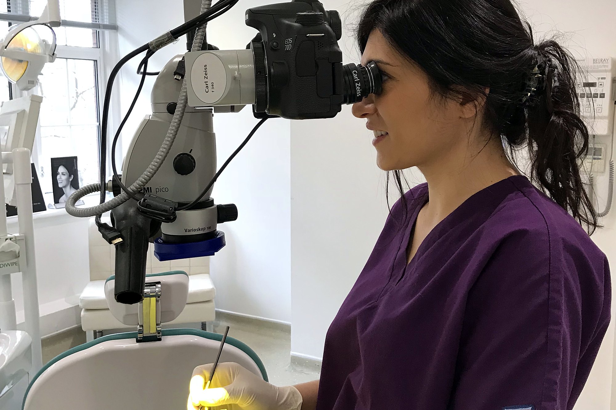 A clinician working under the operating microscope