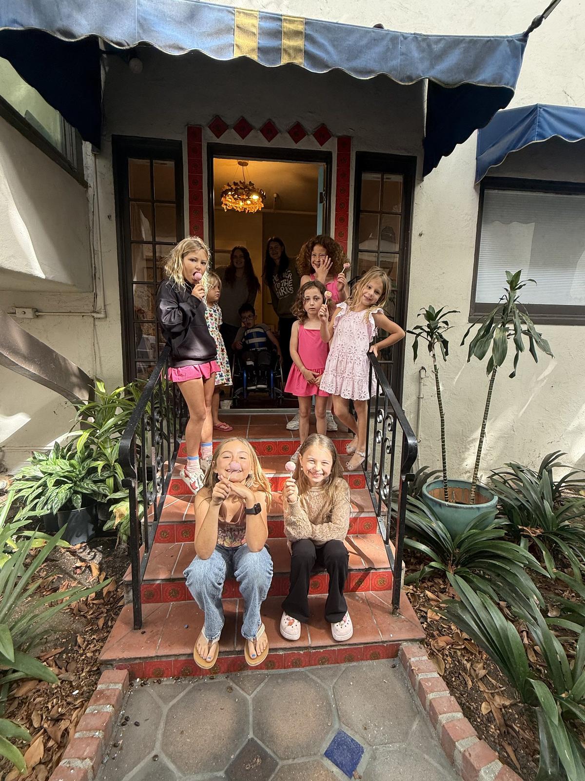 Kids sitting on the steps outside the Monarch Soul studio