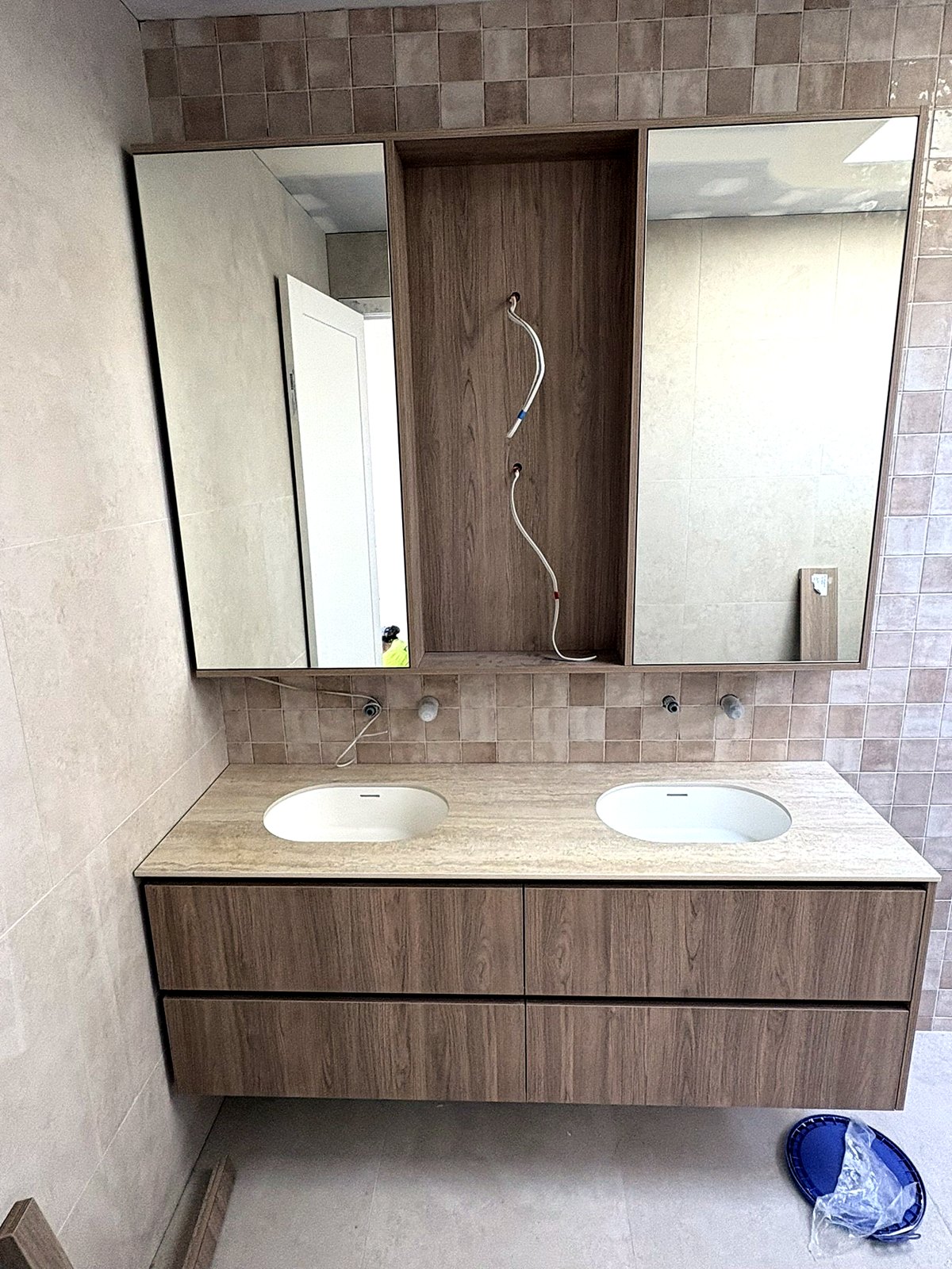 Sintered travertine double vanity with timber cabinetry