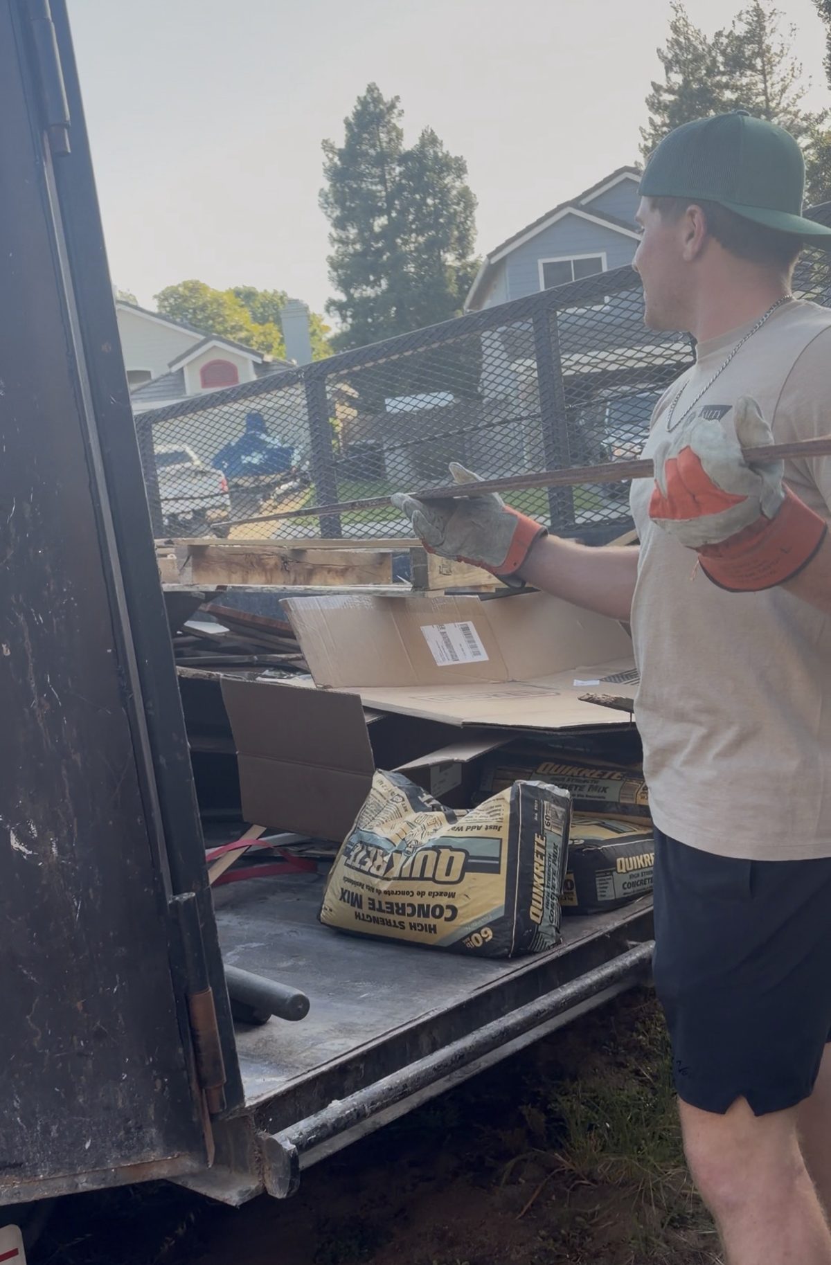 Loading wood and cardboard into the Jake's Junk Away trailer on a cleanout job