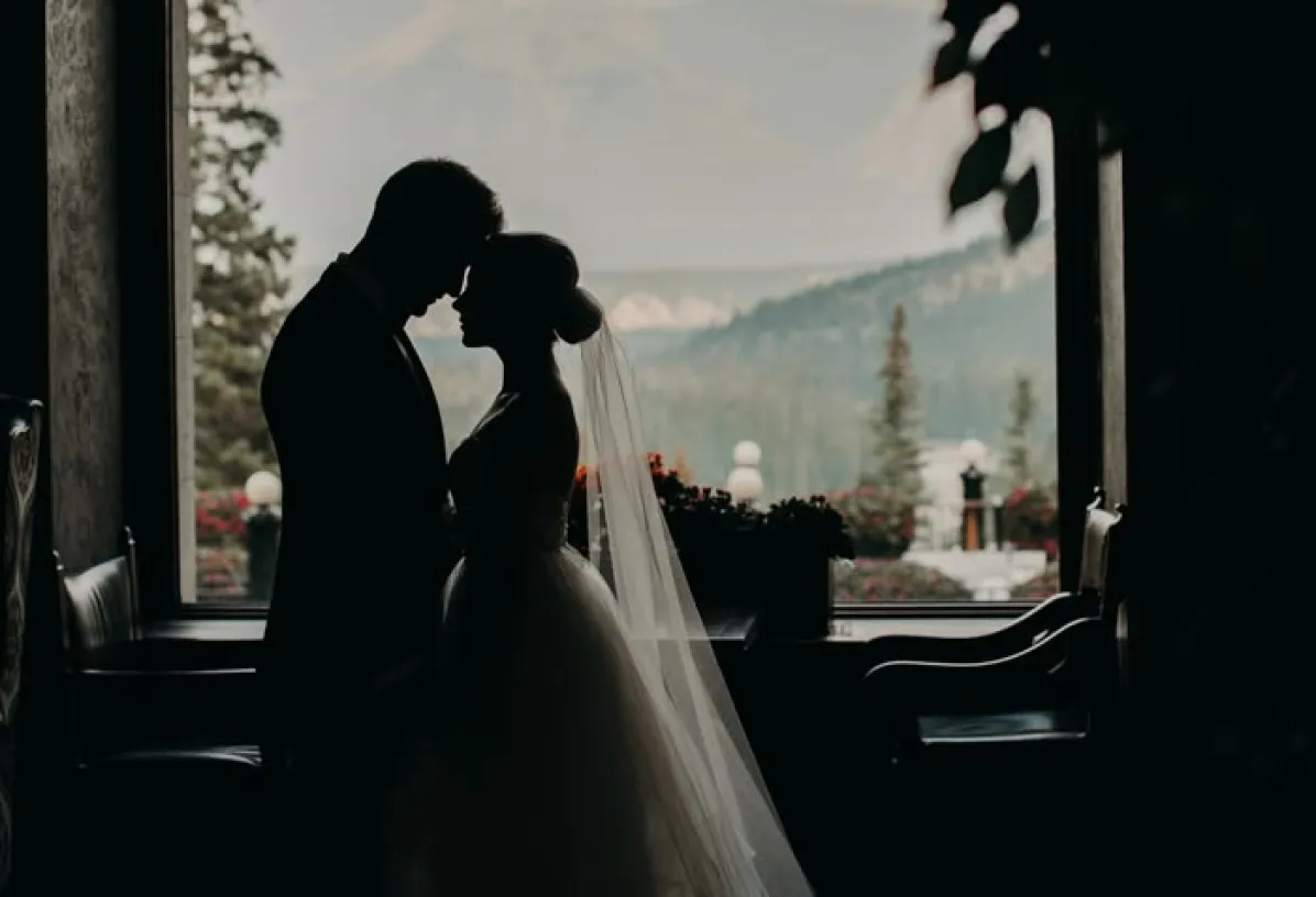 Couple silhouette kissing by a bright window