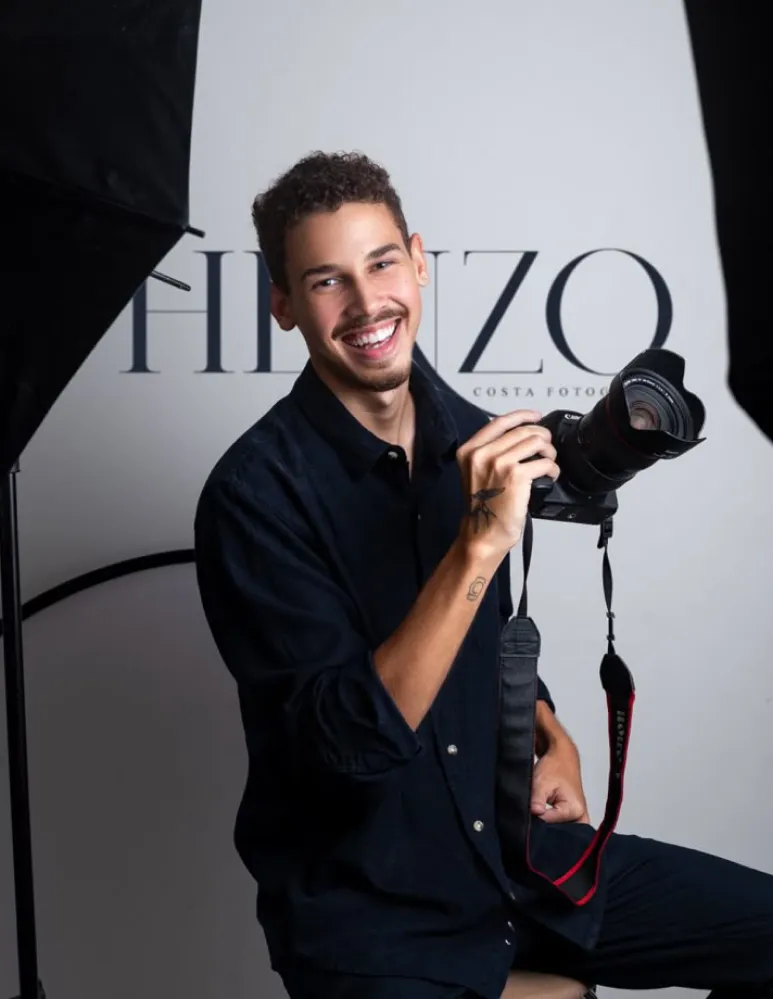 Photographer holding a camera in the studio