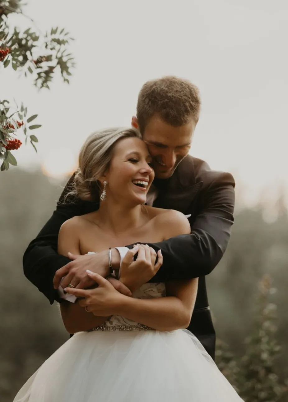 Bride and groom embracing outdoors