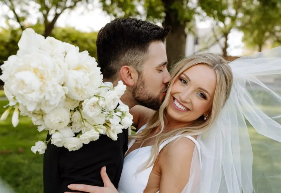Bride and groom with bouquet outdoors