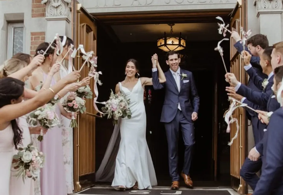 Newlyweds walking out through a doorway