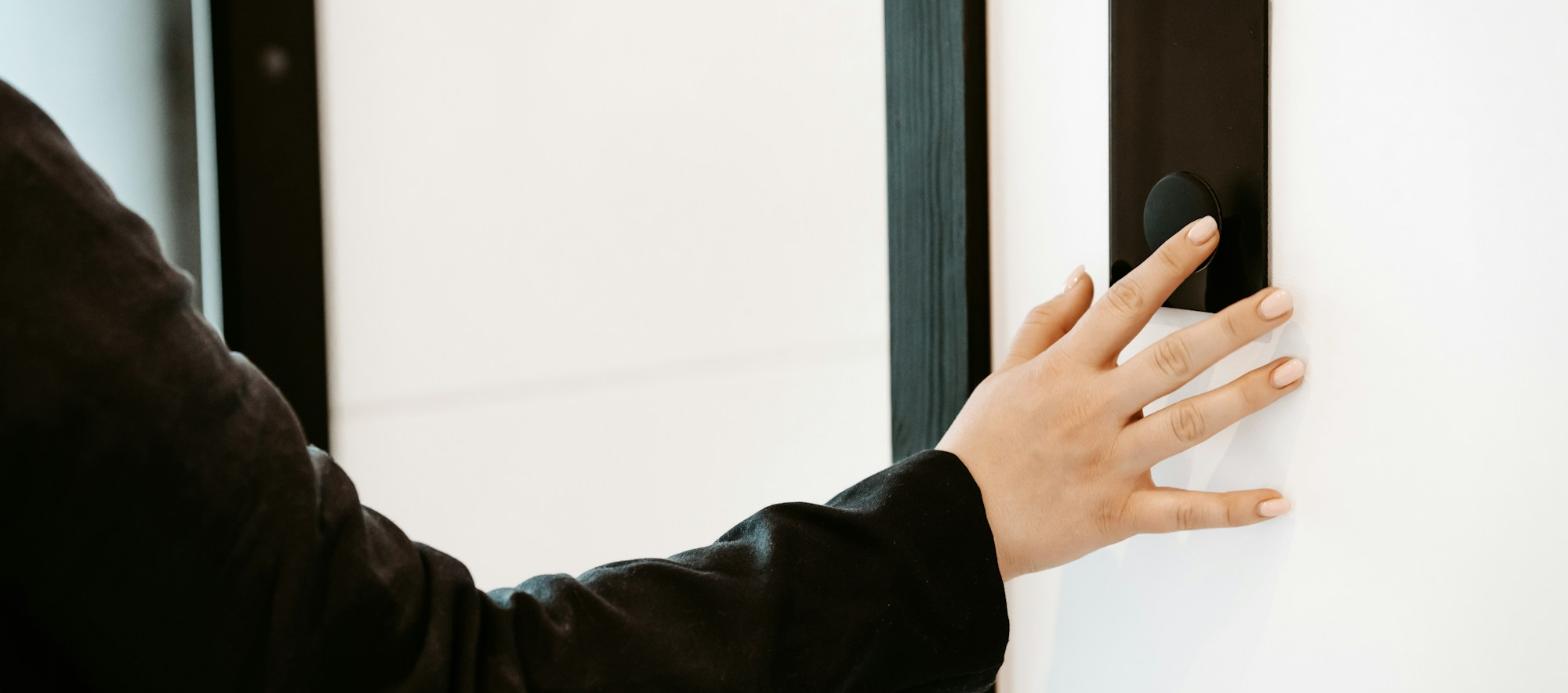 Employee unlocking an office door with an access control card reader