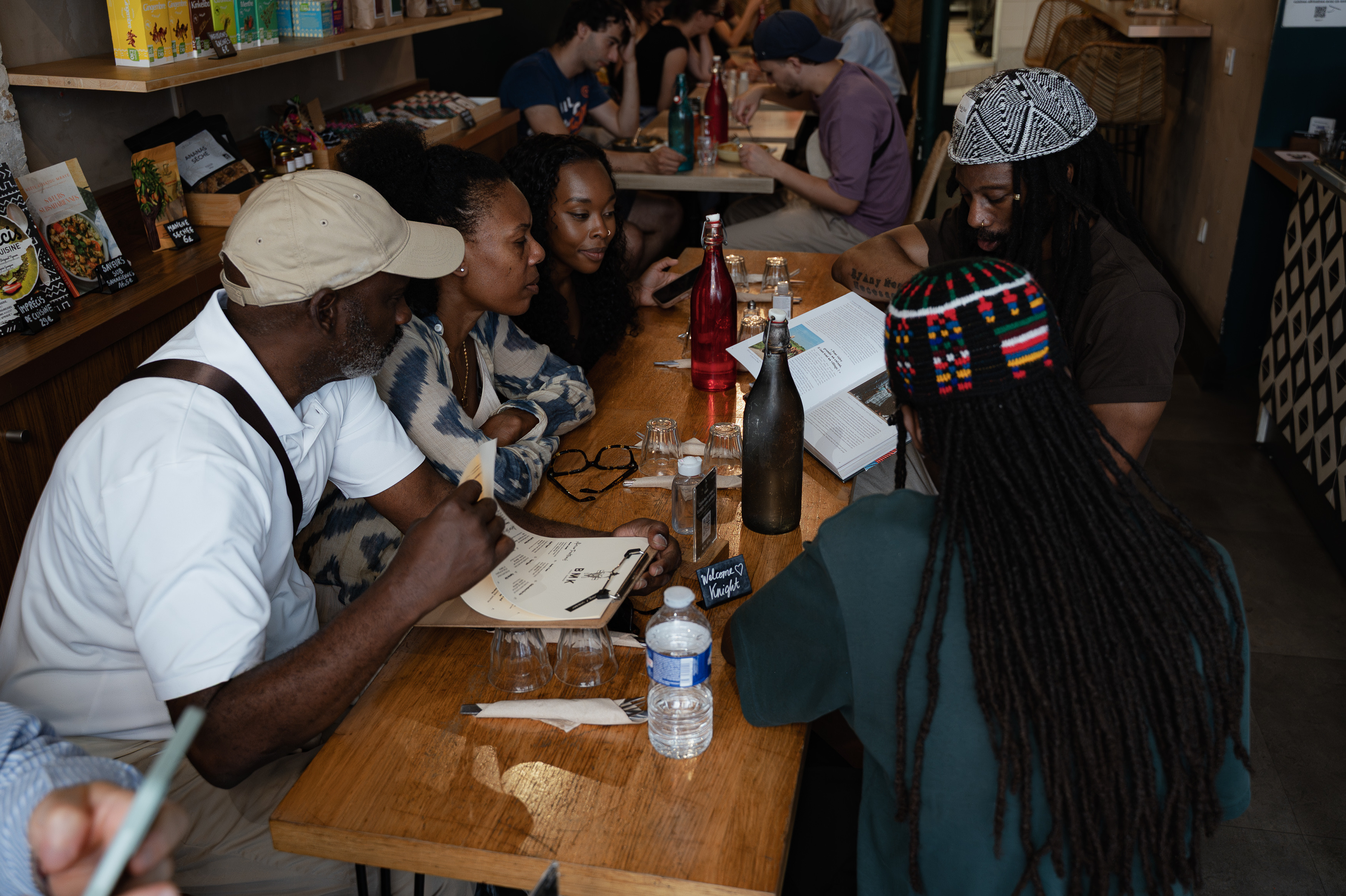 Knight and guests gathered in conversation around a restaurant table in Paris