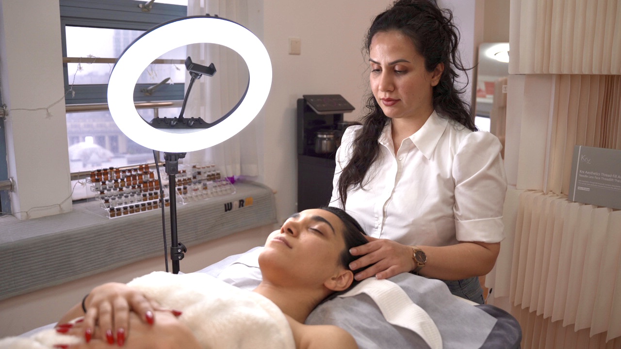 Dr. Blossom caring for a relaxed client at Mahjan SkinCare