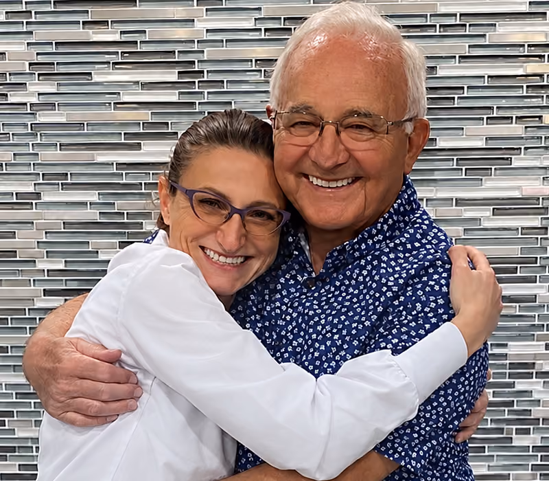 Dr. Gekht hugging a patient