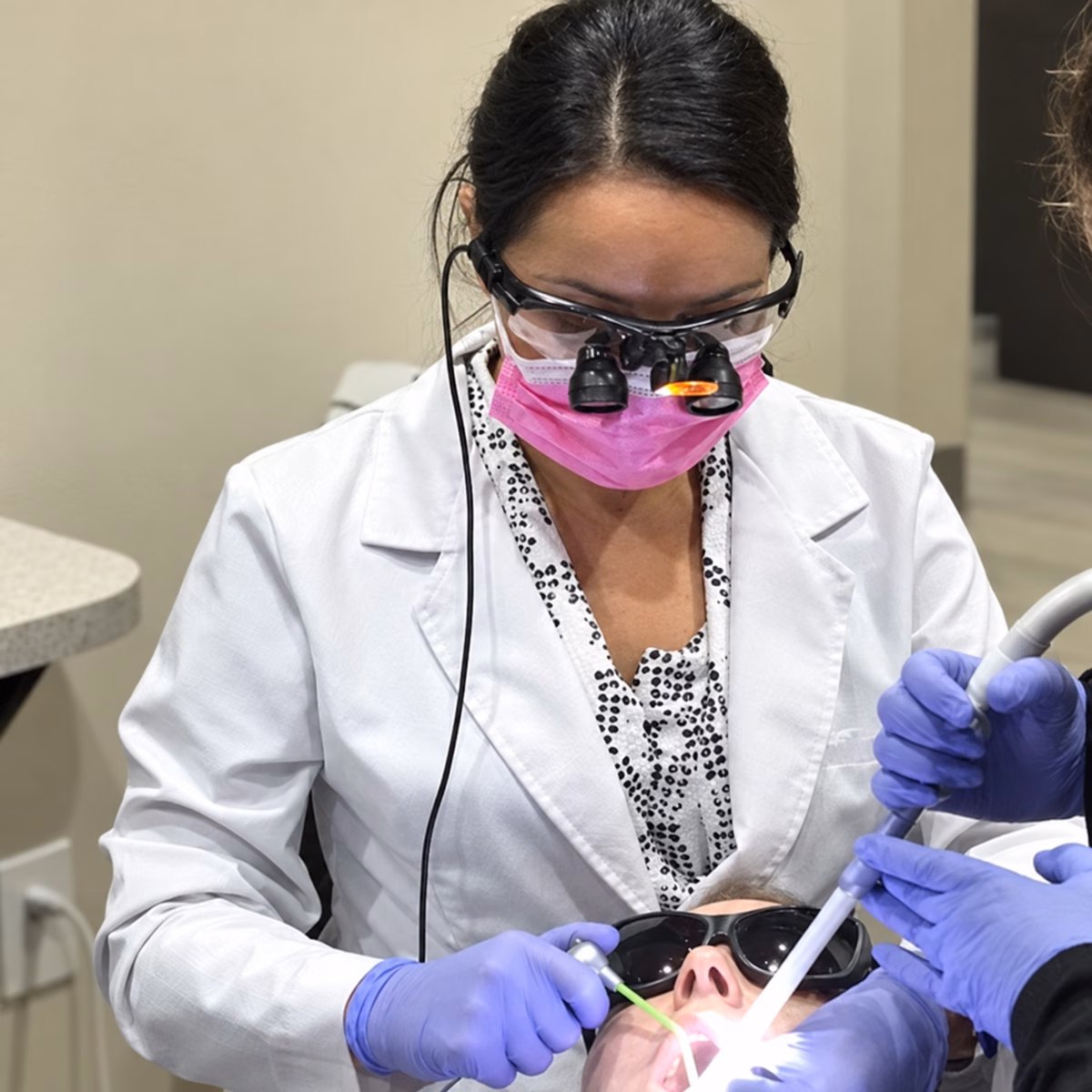 Dental team caring for a patient at Simply Smiles