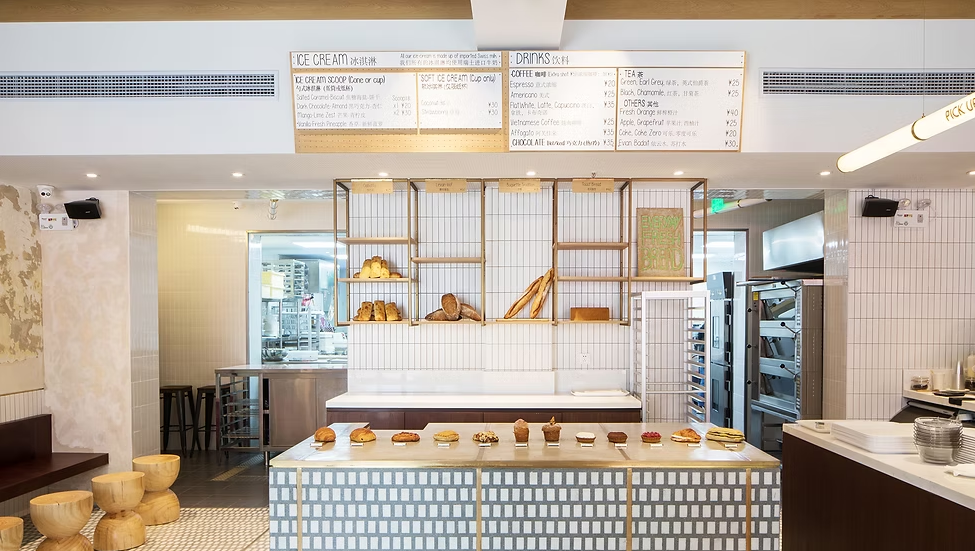 Cafe counter with a branching timber shelf, hexagon tile front and a glass display cabinet