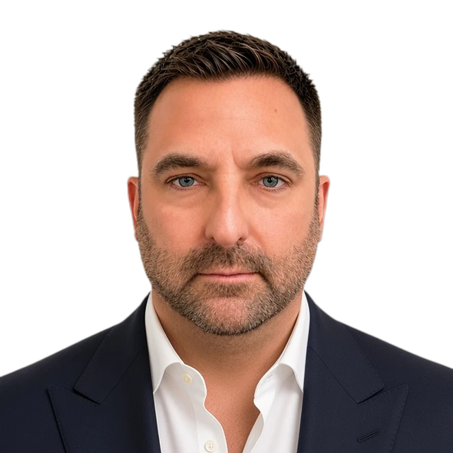 Wesley Nye, President of Ascendesign, headshot in a navy suit jacket and white open-collar shirt