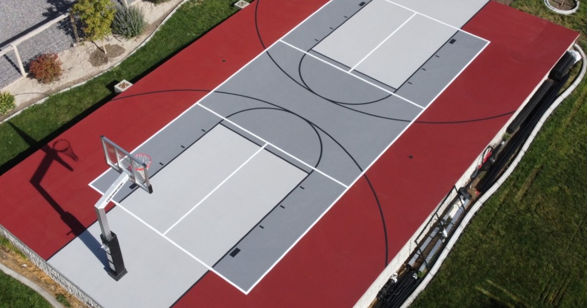 Aerial view of a red and gray ACE Courts court with basketball and pickleball lines.