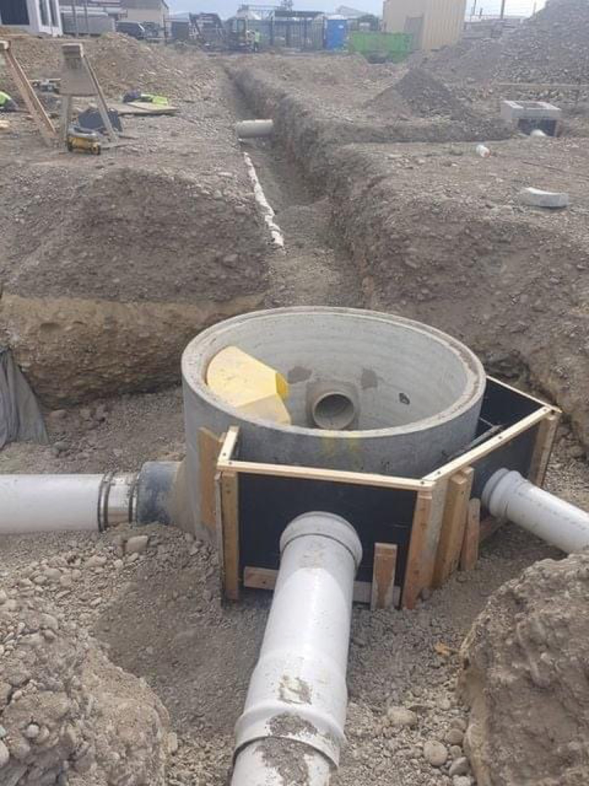Sewer manhole and pipework being installed