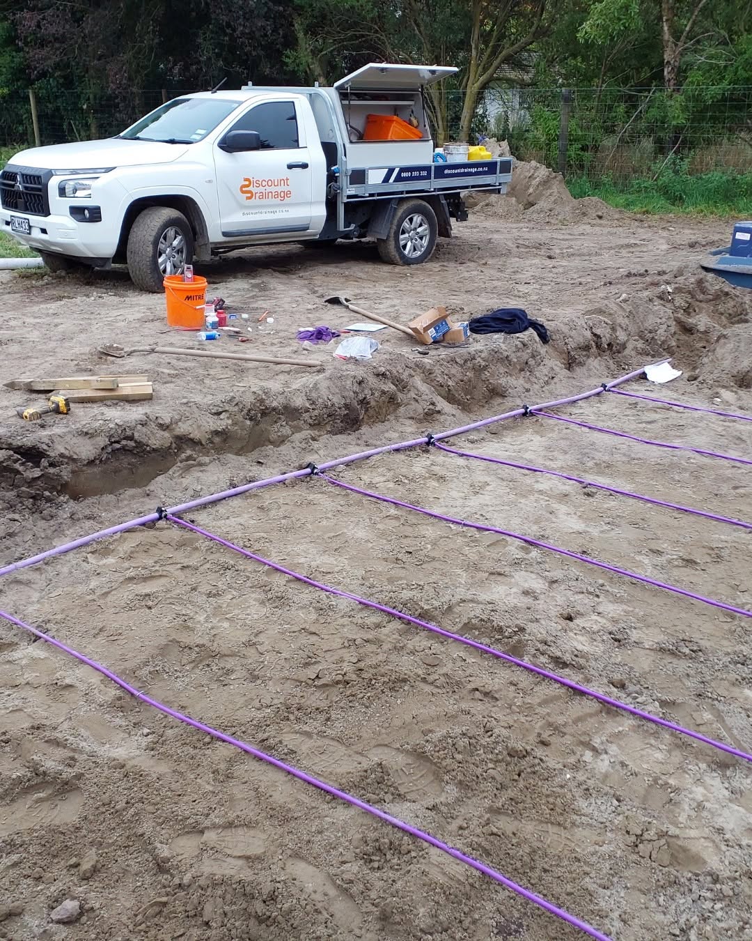 Service line connections laid out on site with a Discount Drainage ute behind
