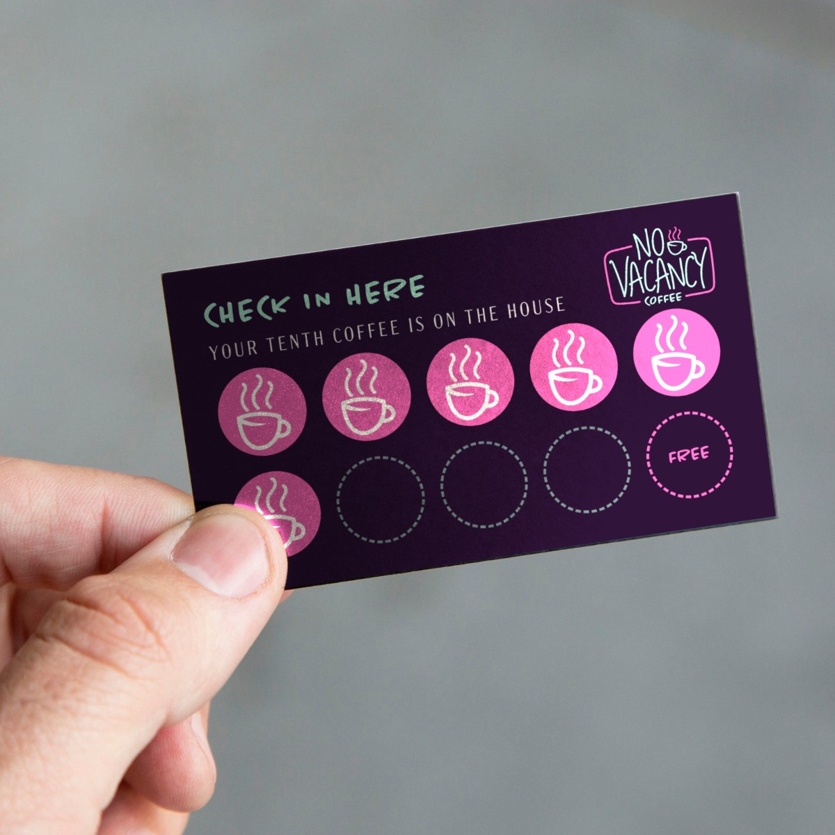 No Vacancy loyalty stamp card held between fingers