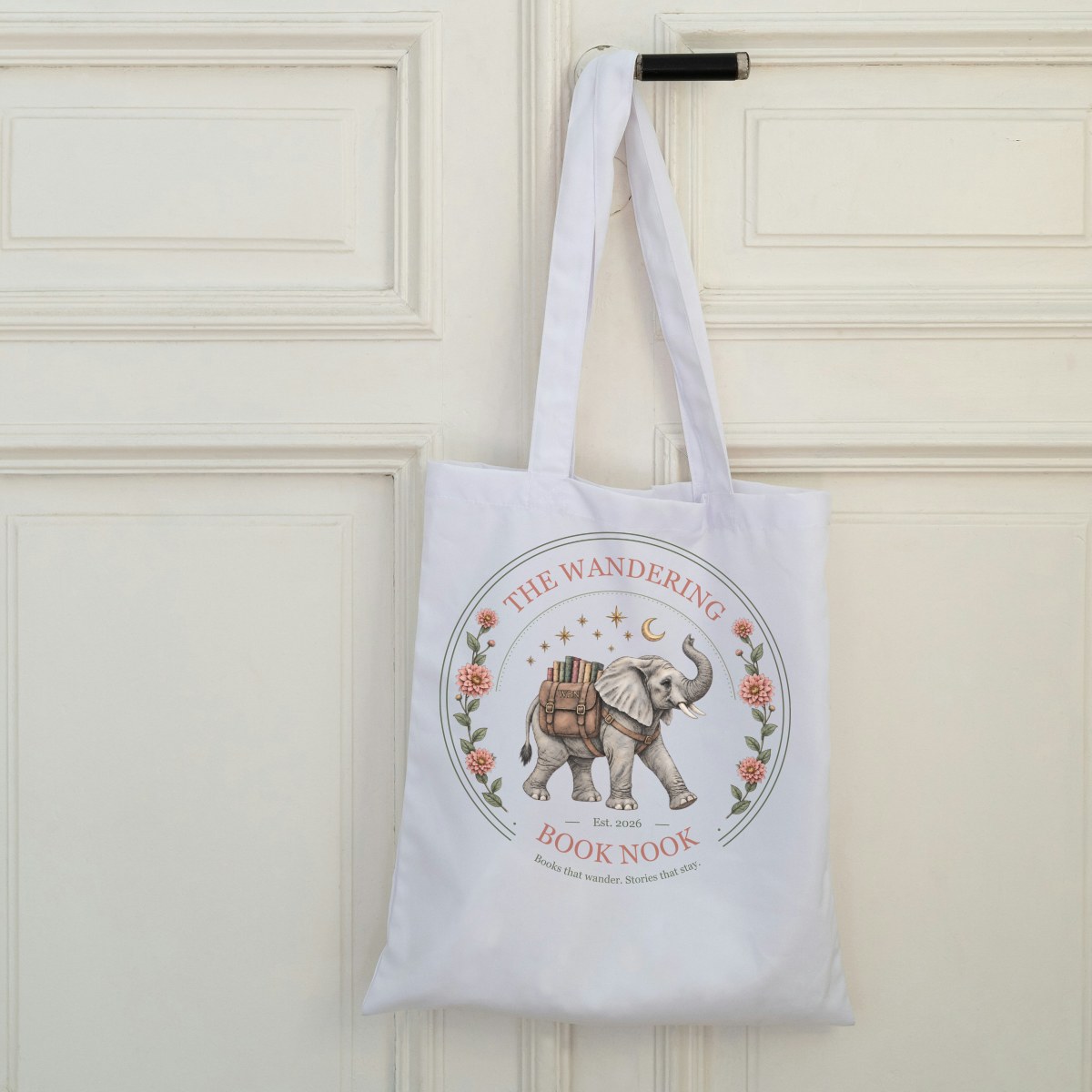 White canvas tote with the elephant badge hanging on a door handle