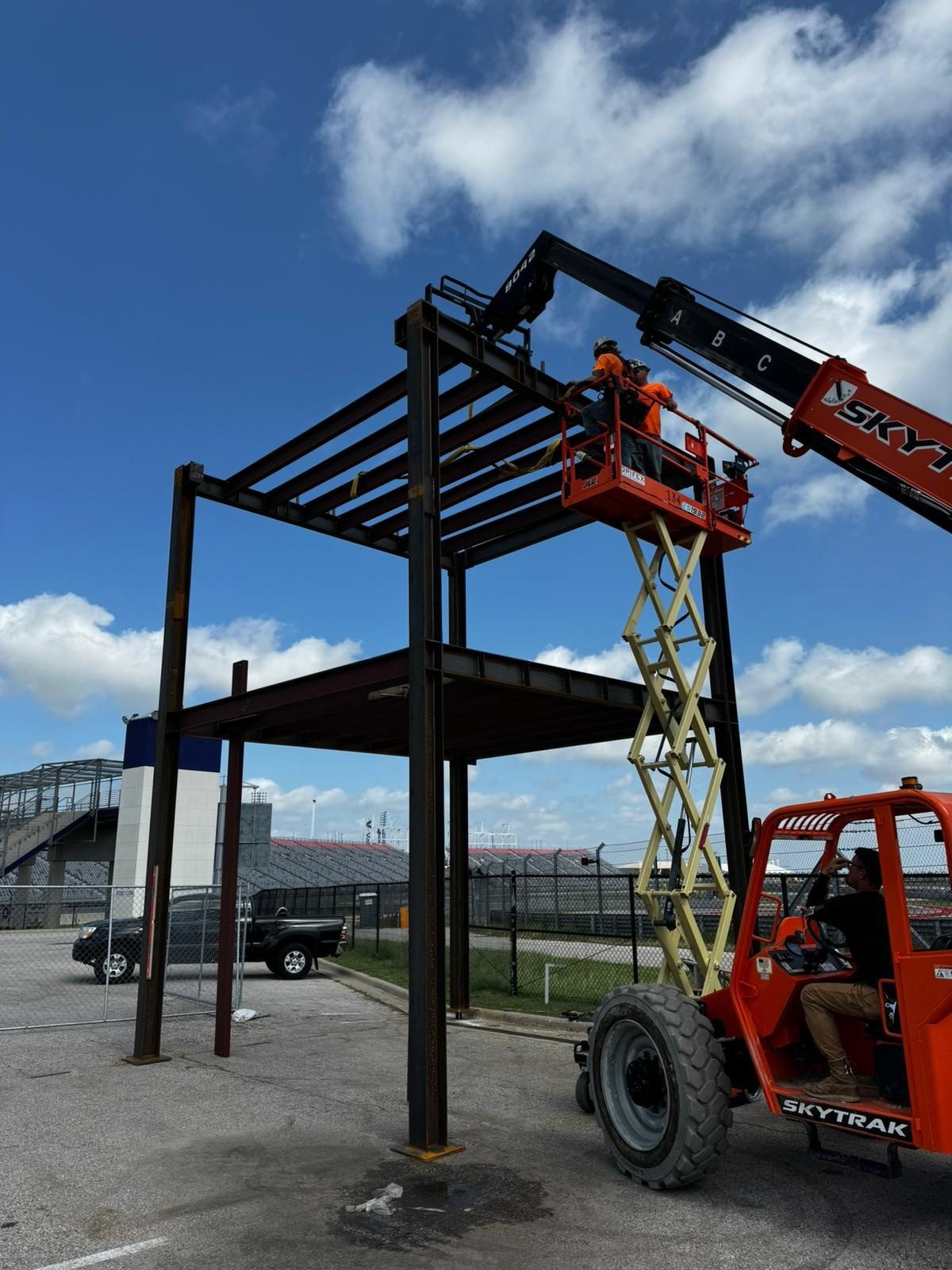 Steel frame being assembled on site with a lift