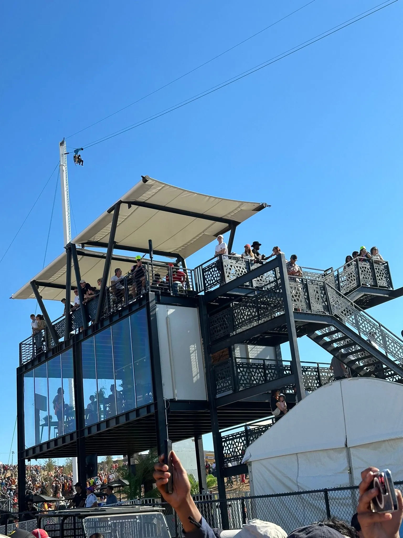 Guests on the rooftop deck, stairs and lower level of the hospitality module during the race weekend at Circuit of the Americas, Austin