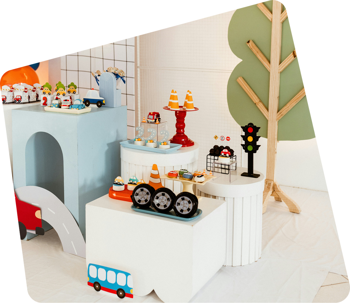 A playroom corner with a wooden tree and toy town