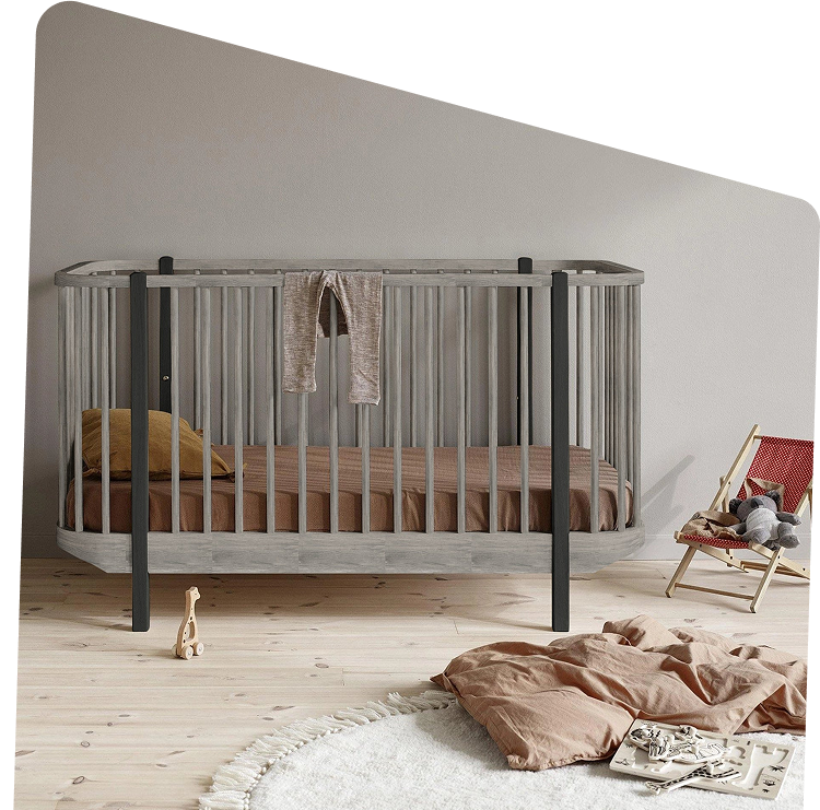 A grey wooden crib in a calm nursery