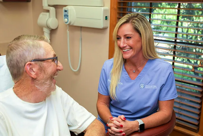 Dental professional and patient smiling during a visit
