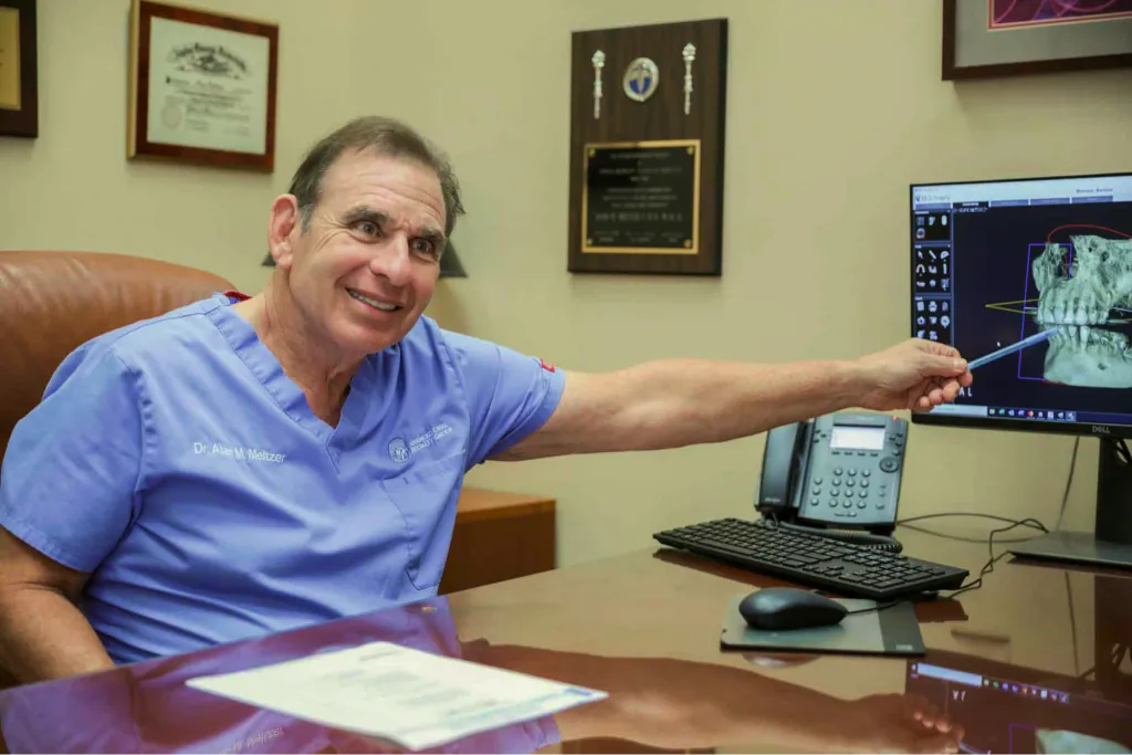 Dr. Meltzer reviewing a dental scan on a computer
