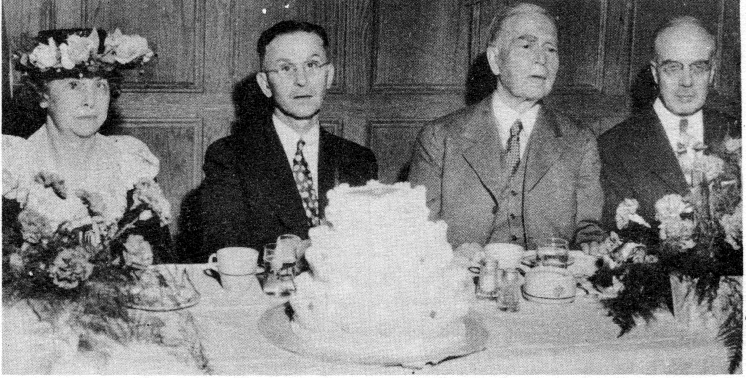 Henry E. Wilson (right) at the speakers' table of the University YMCA's dinner for the YMCA centennial, May 1944. With him, from left, are Mrs. C. L. Metcalf, Prof. C. L. Metcalf, chairman of the Board of Directors, and Dr. John R. Mott. From The Y's Indian, 1944.
